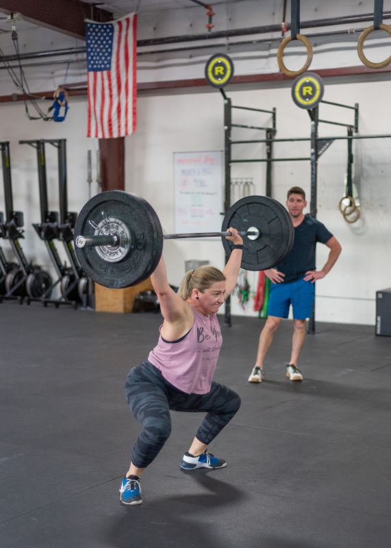 Ryan Coaching Erica at the CrossFit Gym